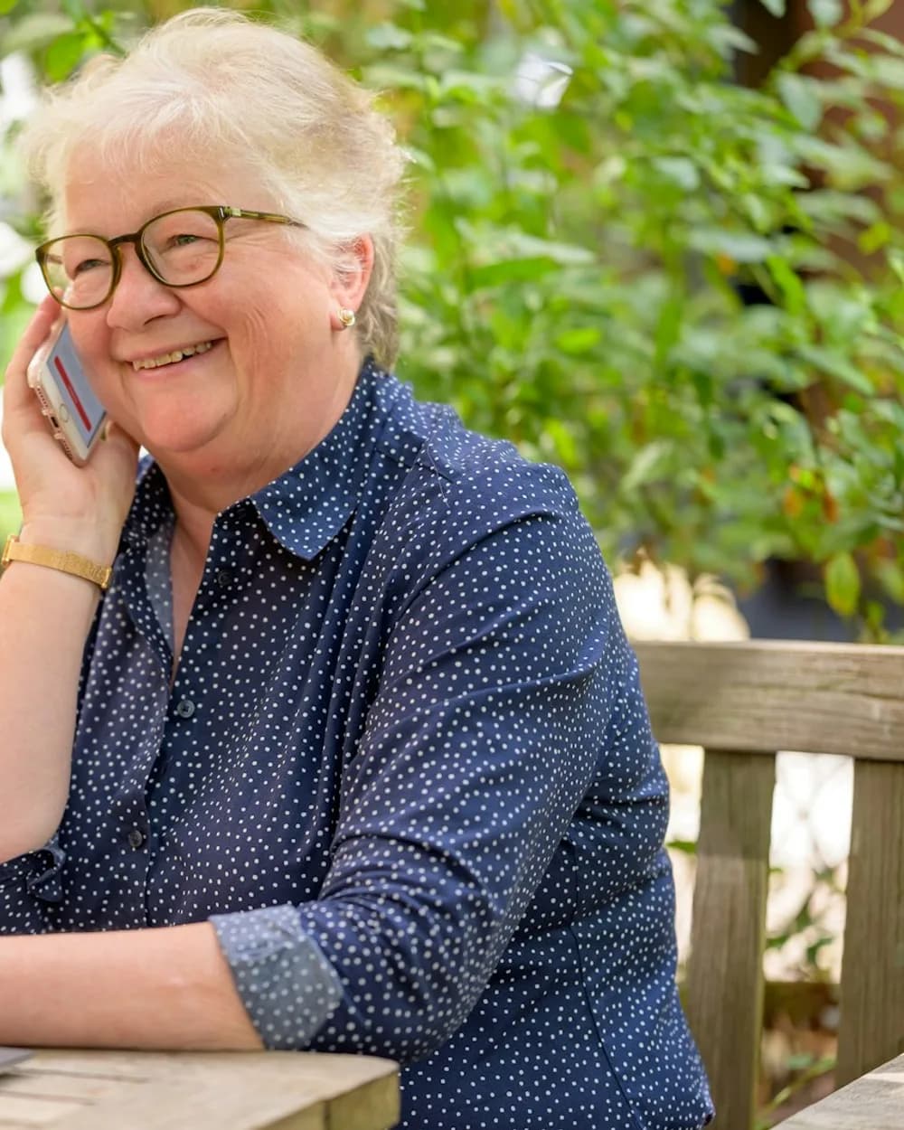 Smiling woman at home on a call with her provider, laptop open