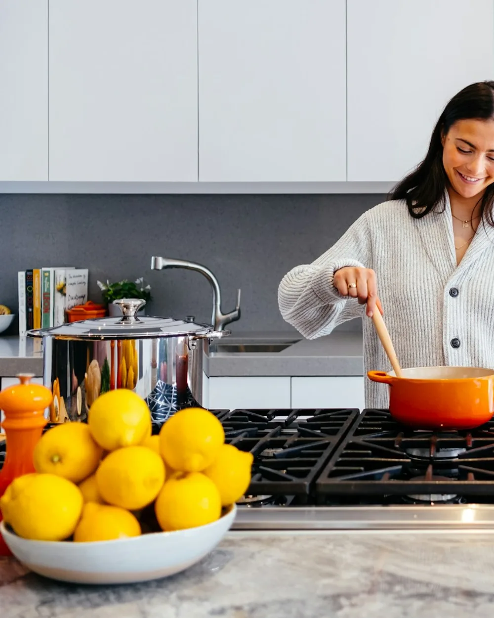 Woman cooking a fresh meal on the stove in her home kitchen