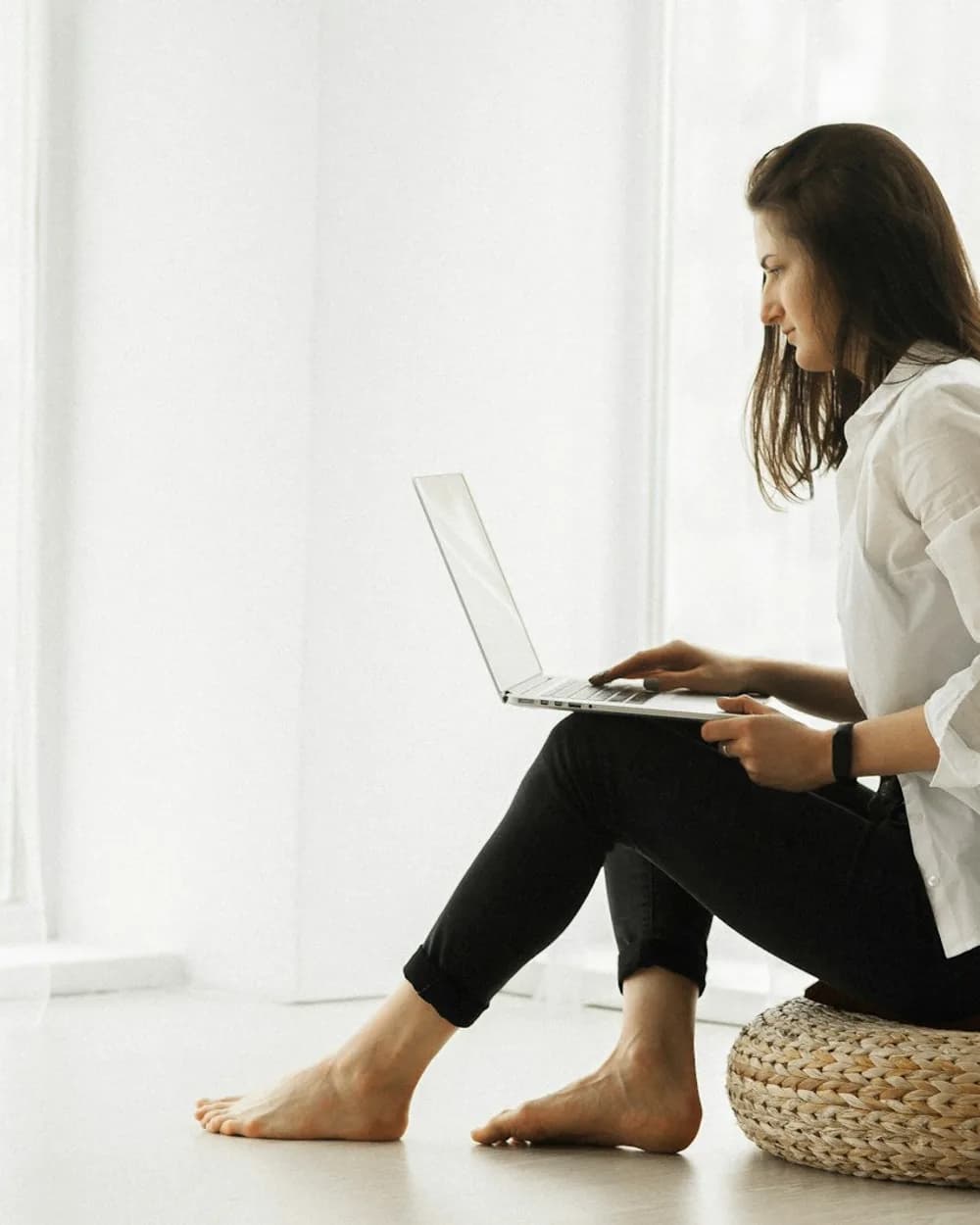 Woman at home on a telehealth visit with her laptop